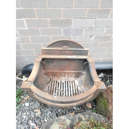 461 - Antique cast iron fire basket, with rising sun pediment, raised on scrolled supports. Height 62cm.