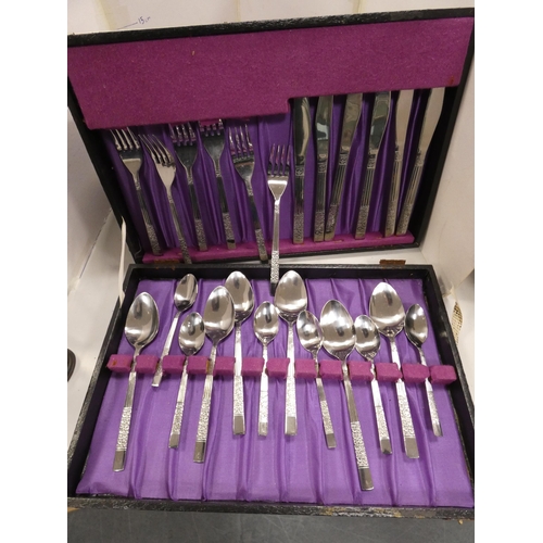 121 - Canteen of stainless steel cutlery, in fitted case, other stainless steel butter knives and another ... 