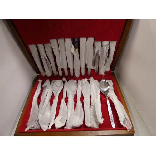 121 - Canteen of stainless steel cutlery, in fitted case, other stainless steel butter knives and another ... 