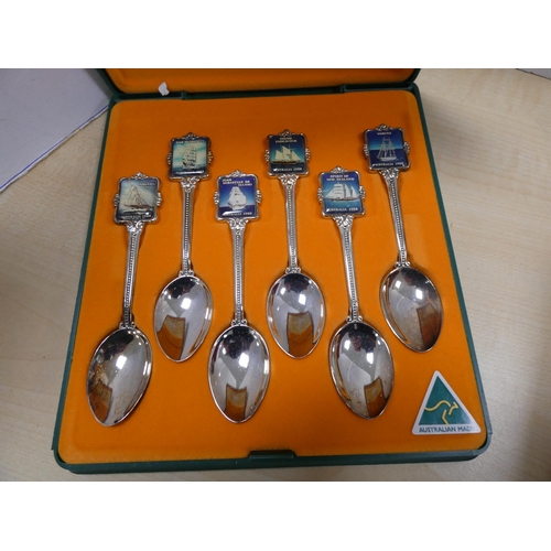 134 - Boxed cutlery to include souvenir spoons, butter knives, teaspoons and tongs etc.