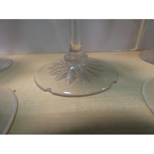 148 - Set of six green glass wine glasses with star-cut bases.