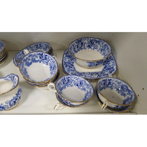 202 - Minton 'Claremont' pattern tablewares decorated with blue and white scrolls (one shelf).