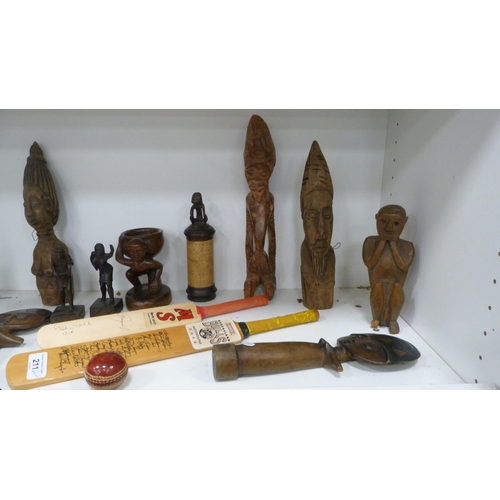 211 - Tribal African-style figures, model cricket bats and ball, banknote prints, Bibby's annual etc (two ... 