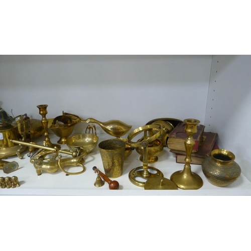 224 - Brassware to include Indian-themed examples, ornaments, beaker, teapots, cruisie lamps, lion figure,... 