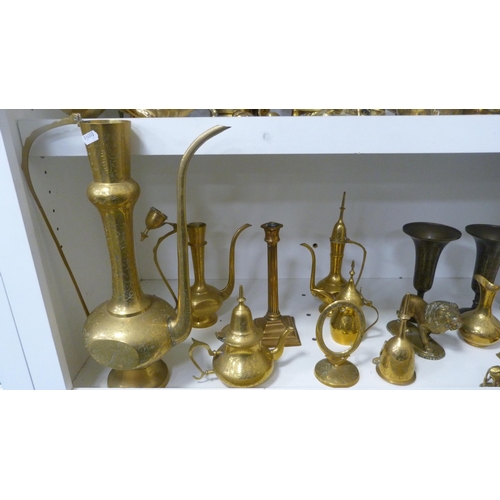 224 - Brassware to include Indian-themed examples, ornaments, beaker, teapots, cruisie lamps, lion figure,... 