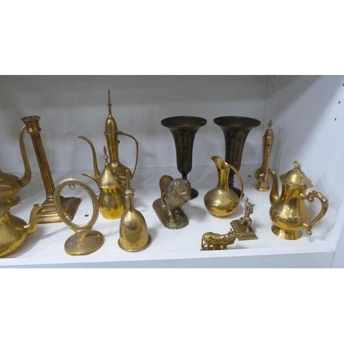 224 - Brassware to include Indian-themed examples, ornaments, beaker, teapots, cruisie lamps, lion figure,... 