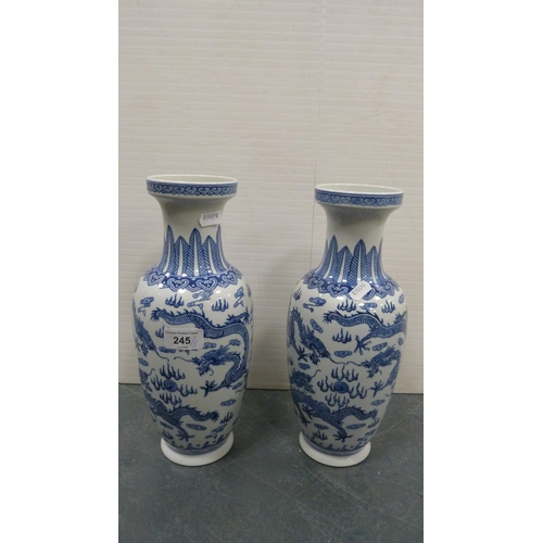 245 - Pair of Chinese Qianlong-style blue and white vases decorated with five-clawed dragon chasing the fl... 