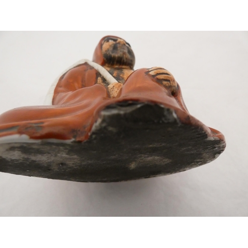 268 - Japanese glazed pottery figure of Bodhidharma, glazed in red.