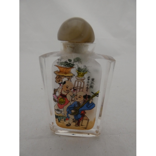 283 - Chinese glass snuff bottle and stopper, and a small scent bottle (lacking stopper).  (2)