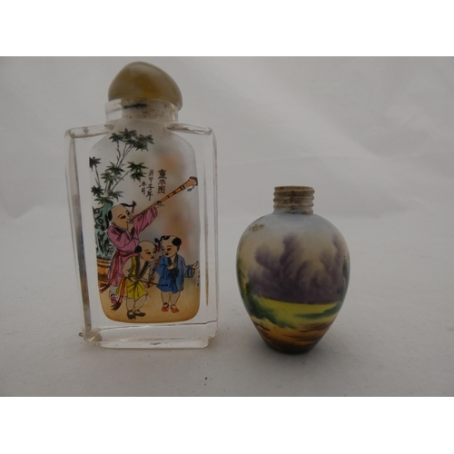 283 - Chinese glass snuff bottle and stopper, and a small scent bottle (lacking stopper).  (2)