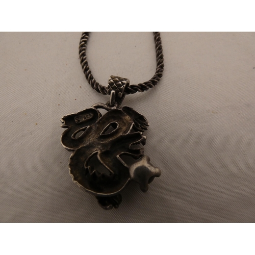 292 - Silver (925) pendant in the form of a dragon on a silver (925) chain, 31g gross.