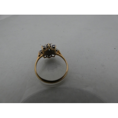 299 - 9ct gold lady's cluster dress ring, set with synthetic stones, 2.2g gross.