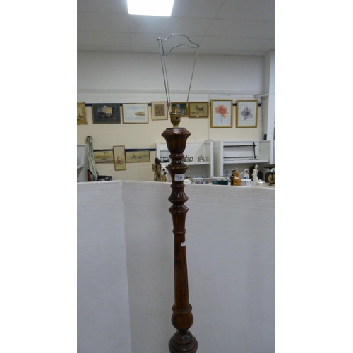 337 - Mahogany floor lamp and shade, and an oval wall mirror.  (2)