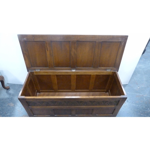 360 - Oak coffer with four-section panelled hinged top and carvings to the frieze.