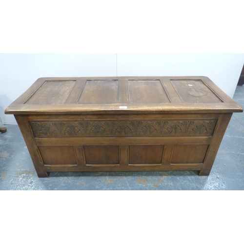 360 - Oak coffer with four-section panelled hinged top and carvings to the frieze.