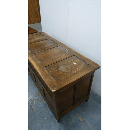 360 - Oak coffer with four-section panelled hinged top and carvings to the frieze.