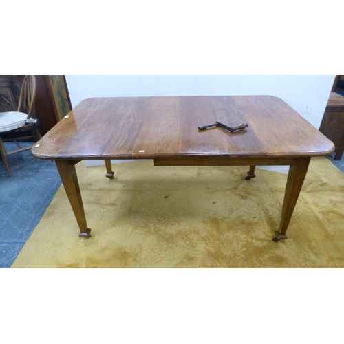 370 - Early 20th century oak extending dining table with additional leaf and winder.