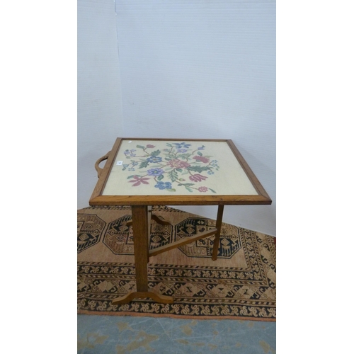 373 - Oak fire screen table with needlepoint floral embroidered screen.