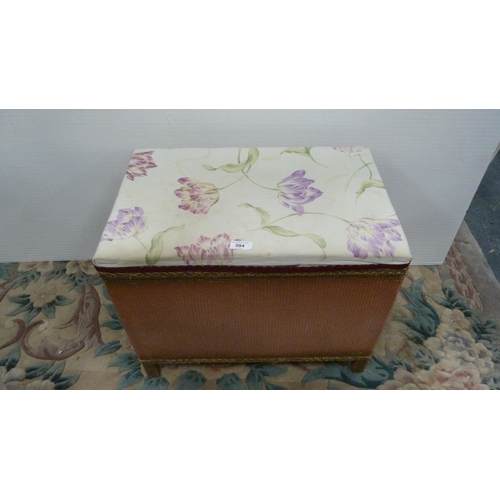 394 - Lloyd Loom-style pink wicker storage box with padded top.