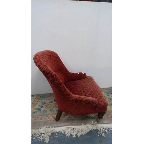 396 - Victorian mahogany armchair upholstered in later red floral fabric, on castors.