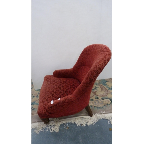 396 - Victorian mahogany armchair upholstered in later red floral fabric, on castors.