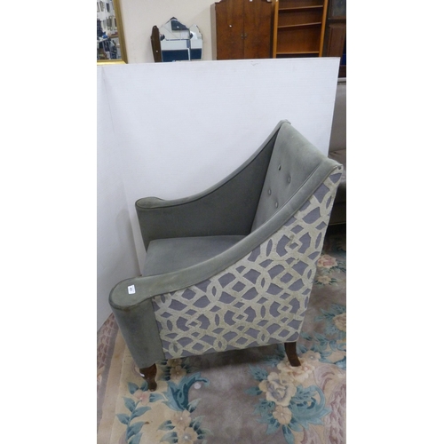 403 - Contemporary button-back armchair upholstered in grey.