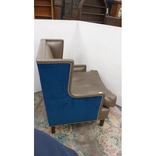 404 - Contemporary wing armchair upholstered in blue velour and hide.