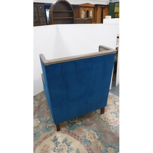 404 - Contemporary wing armchair upholstered in blue velour and hide.