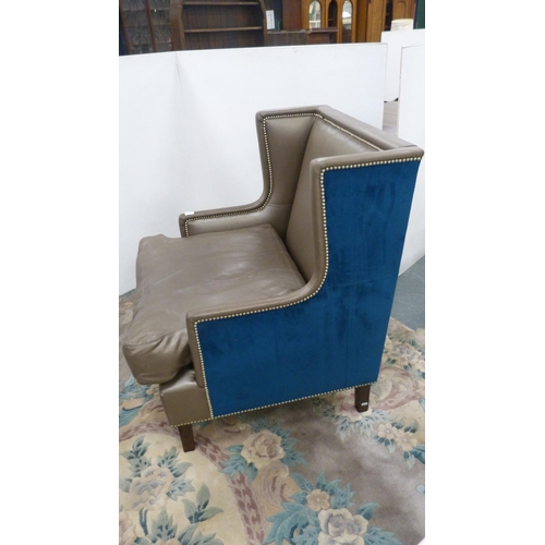 404 - Contemporary wing armchair upholstered in blue velour and hide.