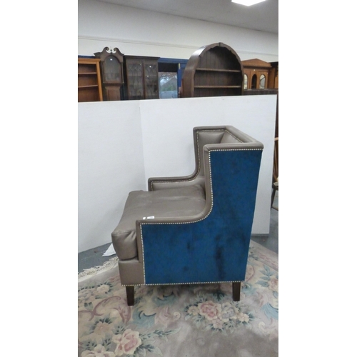 405 - Contemporary wing armchair upholstered in blue velour and hide.