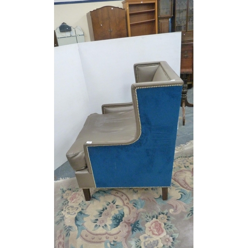 406 - Contemporary wing armchair upholstered in blue velour and hide.