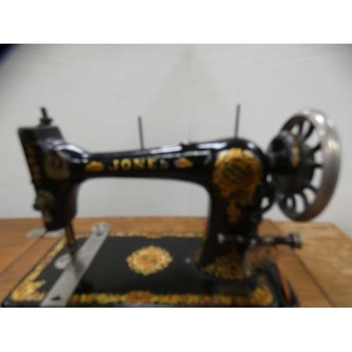 410 - Vintage Jones sewing machine on treadle base.