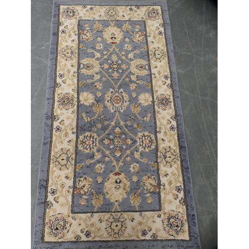 414 - Pair of machine-made Persian design rugs, cream field on blue ground.  (2)