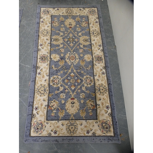 414 - Pair of machine-made Persian design rugs, cream field on blue ground.  (2)