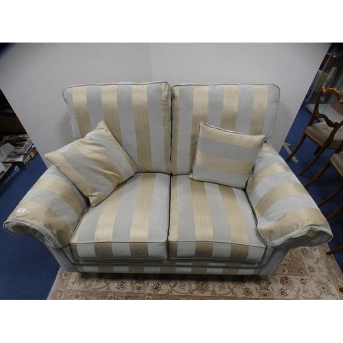 428 - Contemporary two seater sofa with striped upholstery, on brass caps and castors, by Alstons.