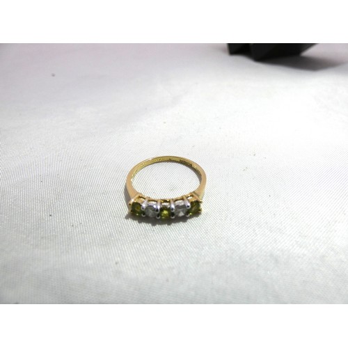 304 - 9ct gold lady's five-stone dress ring set with peridot-type and synthetic stones, 1.4g gross.