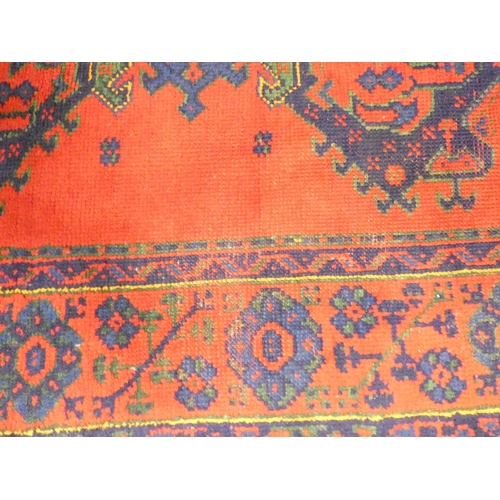 395 - Turkish red ground wool Ushak carpet having four central medallions and flanked by five guls. 250cm ... 