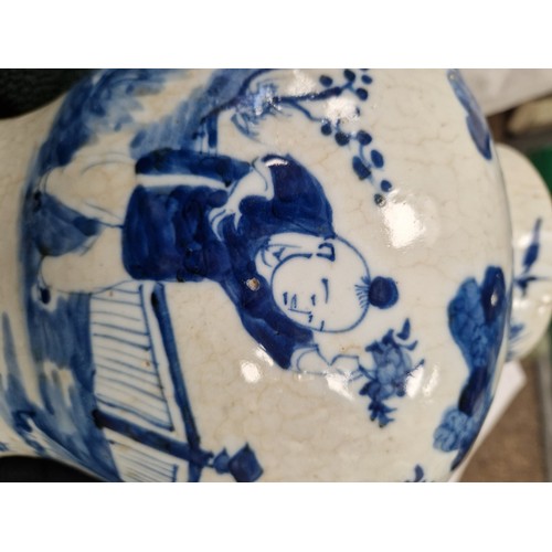 34 - Pair of Chinese glazed blue and white vases with covers, decorated with figures in a garden, 36cm hi... 