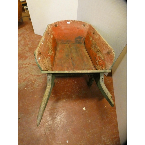 71 - Large painted wooden garden barrow painted in green with red underside, single wheel, 63cm high and ... 