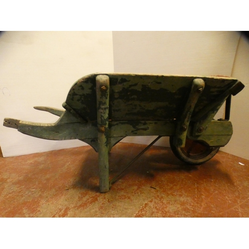 71 - Large painted wooden garden barrow painted in green with red underside, single wheel, 63cm high and ... 