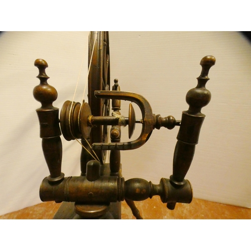 94 - Fruitwood spinning wheel in the 17th century style, 100cm high and approximately 105cm wide.Prov: Sh... 