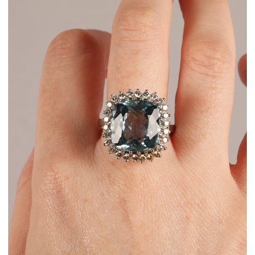 51 - Aquamarine and diamond dress ring, cushion shaped aquamarine with a border of small diamonds on 18ct... 