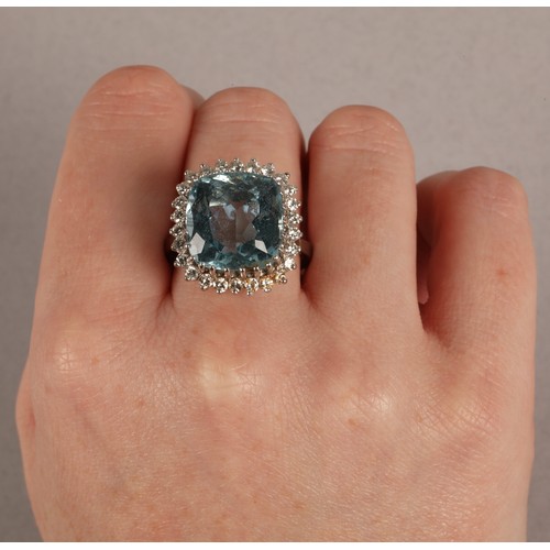 51 - Aquamarine and diamond dress ring, cushion shaped aquamarine with a border of small diamonds on 18ct... 