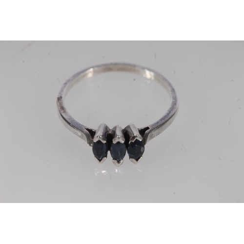 498 - White metal and sapphire three stone ring