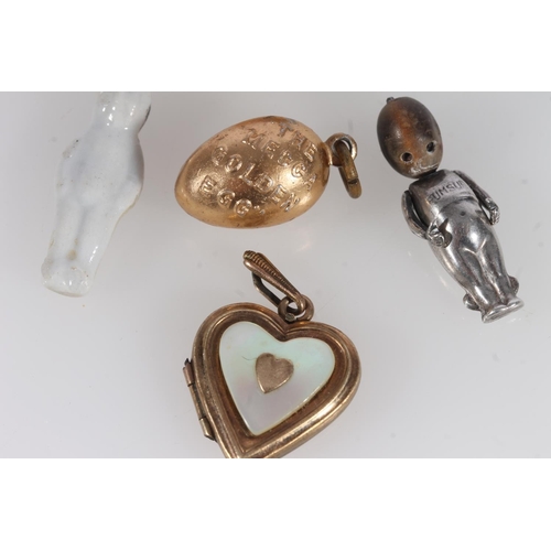 507 - WWI period Fumsup charm, frozen Charlotte doll, Mecca golden egg, small puppy figurine and a rolled ... 