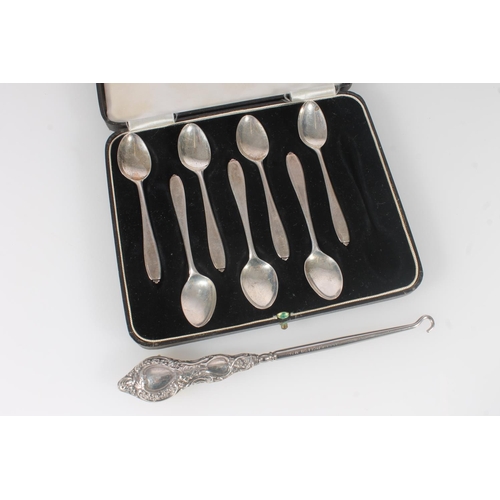 544 - Set of seven hallmarked silver coffee spoons, 51g, together with a silver handled button hook.