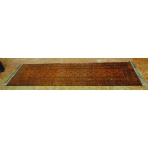 501 - Turkoman Bokhara hand-knotted runner with sixteen rows of two geometric motifs to the centre, furthe... 