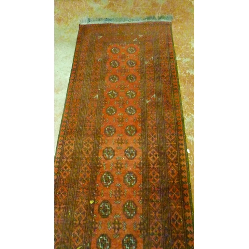 501 - Turkoman Bokhara hand-knotted runner with sixteen rows of two geometric motifs to the centre, furthe... 