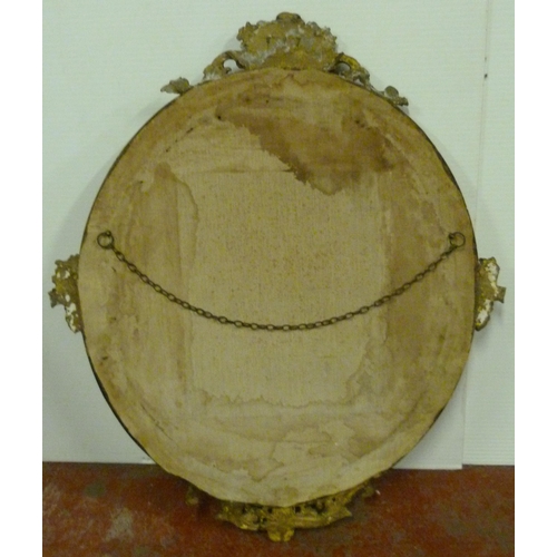 502 - 19th century mahogany gilt wood and gesso wall mirror, the oval plate glass mirror decorated with sc... 