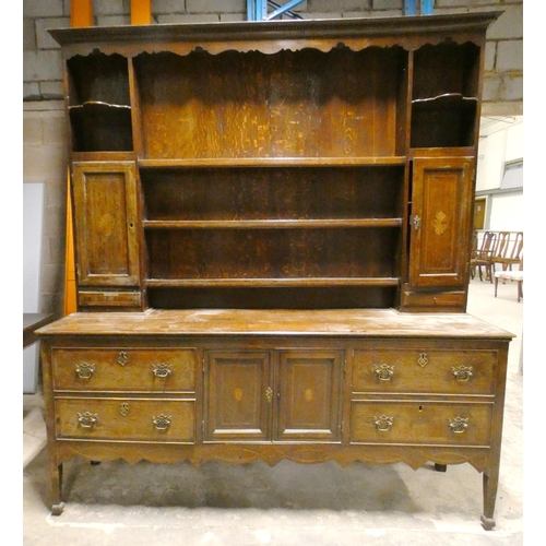 555 - Victorian oak dresser, the top section with open Delft rack flanked by open shelving, above cupboard... 